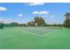 Well-maintained tennis court with new green surface at 6637 Taeda Dr, Sarasota, FL 34241