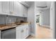A fully equipped wet bar featuring marble countertops, sleek cabinetry, and a stainless steel beverage cooler at 6637 Taeda Dr, Sarasota, FL 34241