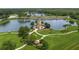 Aerial view of a lighthouse on a lake, surrounded by lush greenery and scenic walking paths at 7015 River Hammock Dr # 204, Bradenton, FL 34212