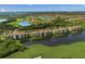 A scenic aerial view of lakeside condos with a golf course and lush landscaping in a vibrant community at 7015 River Hammock Dr # 204, Bradenton, FL 34212