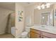 Bright bathroom with a vanity, toilet, tiled floors, and tub-shower combination featuring a shower curtain at 7015 River Hammock Dr # 204, Bradenton, FL 34212