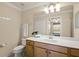 Bathroom featuring a single sink vanity with a large mirror at 7015 River Hammock Dr # 204, Bradenton, FL 34212