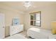 Bedroom with two twin beds and a chest of drawers and a view at 7015 River Hammock Dr # 204, Bradenton, FL 34212