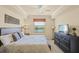 Bedroom with a large dresser, floor lamp, and a window with a view at 7015 River Hammock Dr # 204, Bradenton, FL 34212