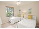 Bedroom with two twin beds and a window providing natural light at 7015 River Hammock Dr # 204, Bradenton, FL 34212