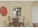 Dining area featuring a glass table, wicker chairs, and chandelier lighting at 7015 River Hammock Dr # 204, Bradenton, FL 34212