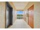 Hallway with elevator and multiple doors leading outside to a balcony with a view at 7015 River Hammock Dr # 204, Bradenton, FL 34212