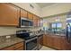 Close up of the kitchen with granite countertops and stainless steel appliances at 7015 River Hammock Dr # 204, Bradenton, FL 34212