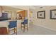 Cozy kitchen with a breakfast bar and two stools at 7015 River Hammock Dr # 204, Bradenton, FL 34212