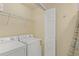 Functional laundry room featuring a washer, dryer, wire shelving, and storage space at 7015 River Hammock Dr # 204, Bradenton, FL 34212
