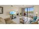 Bright living room with sliding door to the balcony with golf course views at 7015 River Hammock Dr # 204, Bradenton, FL 34212