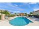 A community pool featuring lounge chairs, palm trees, and a covered gazebo for relaxing by the water at 7015 River Hammock Dr # 204, Bradenton, FL 34212