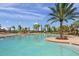 Inviting swimming pool area with ample seating, palm trees, and a relaxing atmosphere at 7015 River Hammock Dr # 204, Bradenton, FL 34212