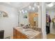 Well-lit bathroom featuring dual sinks, granite countertops and a tile shower at 7401 S Gator Creek Blvd, Sarasota, FL 34241