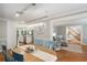 Cozy dining room with modern chandelier and view of the updated kitchen and staircase at 7401 S Gator Creek Blvd, Sarasota, FL 34241