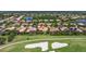 Scenic aerial shot of a residential area showcasing houses with pools and lush green landscape next to a golf course at 8004 River Preserve Dr, Bradenton, FL 34212