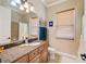 Updated bathroom featuring granite countertops and a shower with neutral tiling at 8004 River Preserve Dr, Bradenton, FL 34212