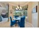 Inviting dining area with blue chairs and view of the screened-in pool at 8004 River Preserve Dr, Bradenton, FL 34212