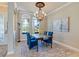 Elegant dining room with a wooden table, upholstered chairs, and chandelier, perfect for Gathering gatherings at 8004 River Preserve Dr, Bradenton, FL 34212