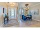 Well-lit dining room with elegant table setting, chandelier, and large windows, perfect for entertaining at 8004 River Preserve Dr, Bradenton, FL 34212