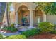 Charming front porch with columns, brick pavers, well-manicured landscaping, and elegant entryway at 8004 River Preserve Dr, Bradenton, FL 34212