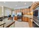 Kitchen with stainless steel refrigerator, and lots of wood cabinets at 8004 River Preserve Dr, Bradenton, FL 34212