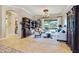 Cozy living room with a bookshelf, plush seating, and views of the outdoor pool area at 8004 River Preserve Dr, Bradenton, FL 34212