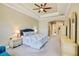 Spacious main bedroom featuring a tray ceiling, ceiling fan and ensuite bathroom at 8004 River Preserve Dr, Bradenton, FL 34212