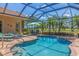 Enjoy the sunny backyard oasis, featuring a pristine pool, spa, and outdoor seating area at 8004 River Preserve Dr, Bradenton, FL 34212
