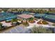 Aerial view of tennis courts featuring a cabana with shade and surrounding landscaping at 8004 River Preserve Dr, Bradenton, FL 34212
