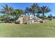 Stunning waterfall feature with 'River Strand' signage surrounded by lush landscaping at 8004 River Preserve Dr, Bradenton, FL 34212