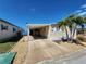 Charming single-story home with palm trees, carport, updated windows, and a well-maintained front yard at 808 53Rd E Ave # 273, Bradenton, FL 34203