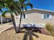 Inviting home exterior with a well-maintained yard and charming curb appeal, enhanced by lush palm trees at 808 53Rd E Ave # 273, Bradenton, FL 34203