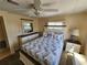 Fully furnished bedroom with a ceiling fan and large window at 808 53Rd E Ave # 273, Bradenton, FL 34203
