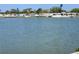 Picturesque lake view featuring waterfront homes along the shore, offering a serene and scenic residential experience at 808 53Rd E Ave # 273, Bradenton, FL 34203