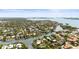 Stunning aerial view of a waterfront community showcasing lush landscaping and coastal living at its finest at 813 Hudson Ave, Sarasota, FL 34236
