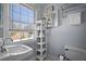 Bathroom features a pedestal sink and an open shelving for towels at 813 Hudson Ave, Sarasota, FL 34236