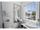 This bright bathroom has a large mirror and a lovely window that provides lots of natural light at 813 Hudson Ave, Sarasota, FL 34236