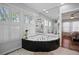 Bright bathroom showcasing a jetted tub and large windows, offering a serene and luxurious experience at 813 Hudson Ave, Sarasota, FL 34236