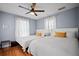 Bedroom with two twin beds, hardwood floors, and a ceiling fan at 813 Hudson Ave, Sarasota, FL 34236