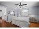 Bright bedroom boasts wood floors, fresh gray paint, white trim, and a large white dresser with decorative mirror at 813 Hudson Ave, Sarasota, FL 34236