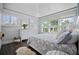 Bright bedroom featuring dark wood floors, tray ceiling, and white trim with lots of natural light at 813 Hudson Ave, Sarasota, FL 34236
