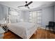 Comfortable bedroom with light blue walls, ceiling fan, and light colored hardwood floors at 813 Hudson Ave, Sarasota, FL 34236