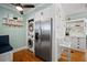 Cozy breakfast nook featuring a stainless fridge, laundry closet, and white bar stools at 813 Hudson Ave, Sarasota, FL 34236