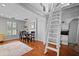 Bright dining area with access to a loft via ladder, hardwood floors, and plenty of light at 813 Hudson Ave, Sarasota, FL 34236