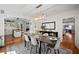 Dining room with wainscoting, hardwood floors, a modern chandelier, and a view to the kitchen and living room at 813 Hudson Ave, Sarasota, FL 34236