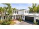 Beautiful two-story home with palm trees, white columns, black shutters and an attached garage at 813 Hudson Ave, Sarasota, FL 34236
