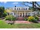 Charming home featuring a brick pathway, lush landscaping, and a welcoming front porch with columns at 813 Hudson Ave, Sarasota, FL 34236