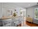 Bright kitchen with counter seating, open layout, and view into a sunlit living space at 813 Hudson Ave, Sarasota, FL 34236