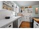 Updated white kitchen showcasing white tiled backsplash, countertops, and stainless steel appliances at 813 Hudson Ave, Sarasota, FL 34236